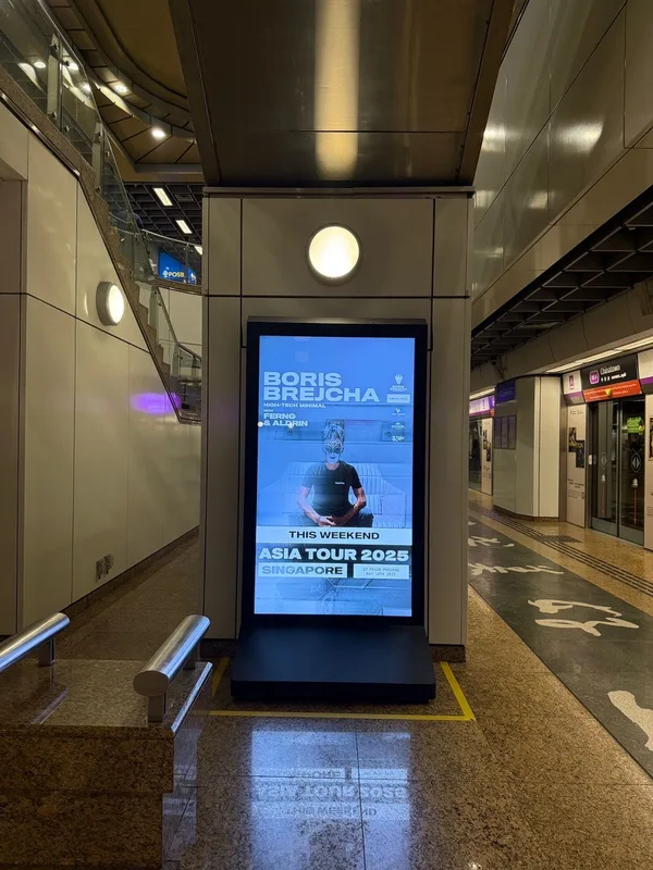 A portrait screen on a train station platform in Singapore
